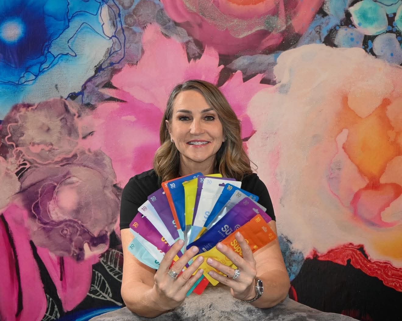 Dena Tocco, the Superpatch Queen, holding the full range of Superpatch wellness patches
